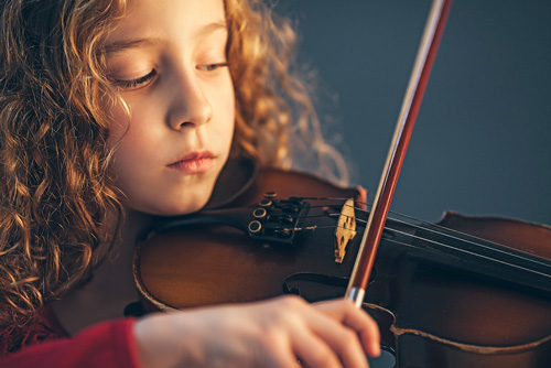 girl playing music instrument